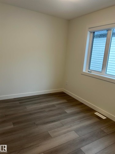 Neutral-toned wall finishes complemented by wood-finish flooring - 11012 132 Street, Edmonton, AB 