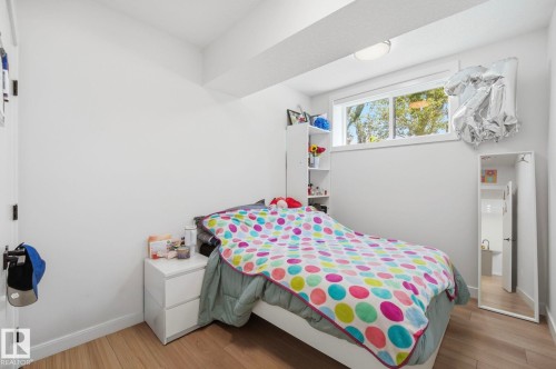 Room featuring light wood-finish flooring, white walls, and a single window - 11012 132 Street, Edmonton, AB 