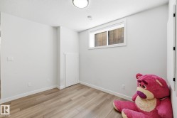Room featuring light wood-finish flooring, white walls, and a single window - 