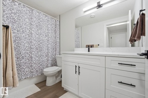 Bedroom space featuring light wood-finish flooring, white walls, and a recessed window - 11012 132 Street, Edmonton, AB 