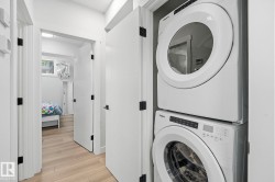 Stackable washer and dryer unit in a hallway laundry closet - 