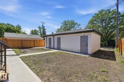 Detached auxiliary building featuring three numbered exterior doors, white siding, and a dark shingle roof - 