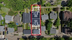 Aerial perspective showcasing a multi-unit property with a prominent solar panel array - 
