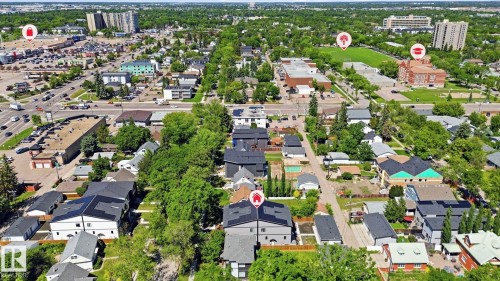 Residential neighborhood featuring mature tree-lined streets, varied housing styles, commercial areas with parking lots, and institutional buildings with green spaces - 11012 132 Street, Edmonton, AB 