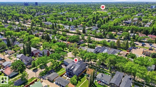 Aerial perspective showcasing a residential area with varied housing styles and abundant mature trees - 11012 132 Street, Edmonton, AB 