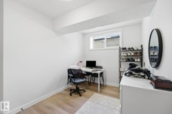 Bright room featuring light wood-finish flooring, white baseboards, and a single window - 