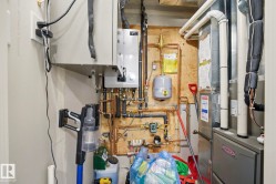 Heating and cooling systems featuring a tankless water heater, copper piping, and a forced air unit - 