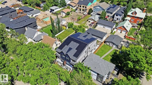 Contemporary multi-level residence featuring solar panels, a dark shingle roof, and light gray exterior siding - 11007 132 Street, Edmonton, AB 