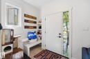 Entryway featuring a white door with a full-length sidelight, wood-finish flooring, built-in shelving, and a window with a screen - 11007 132 Street, Edmonton, AB 