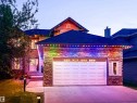 Stone facade residence featuring a two-car garage, concrete driveway, and covered front entry - 5206 Cercle Ciel Crescent, Beaumont, AB 