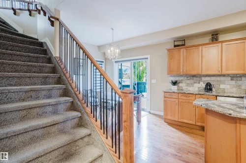 Carpeted staircase with wood handrail and metal balusters - 5206 Cercle Ciel Crescent, Beaumont, AB 