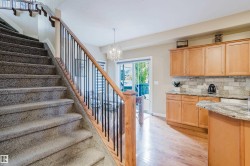 Carpeted staircase with wood handrail and metal balusters - 