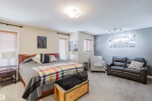 Spacious room featuring neutral carpeting and a light beige wall color - 5206 Cercle Ciel Crescent, Beaumont, AB 
