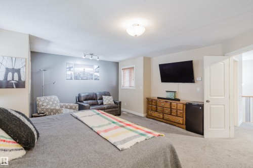 Spacious room featuring neutral carpet flooring and a light-colored ceiling - 5206 Cercle Ciel Crescent, Beaumont, AB 