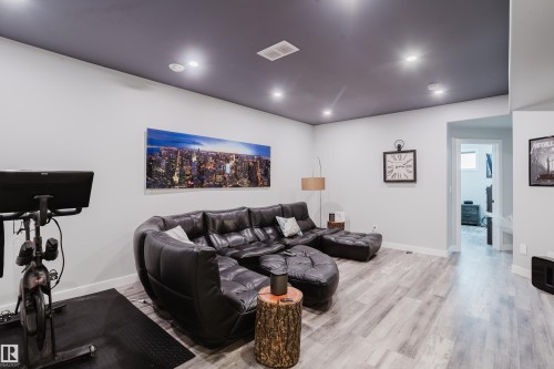 Recreation room featuring wood-finish flooring and recessed lighting - 5206 Cercle Ciel Crescent, Beaumont, AB 