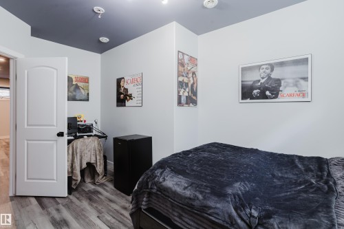 Interior space featuring wood-finish flooring, white walls, and a contrasting dark ceiling - 5206 Cercle Ciel Crescent, Beaumont, AB 