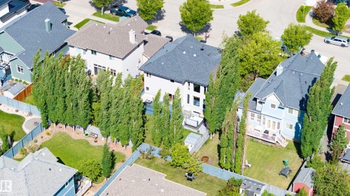 Two-story residence featuring a gray shingle roof and light-colored siding - 5206 Cercle Ciel Crescent, Beaumont, AB 