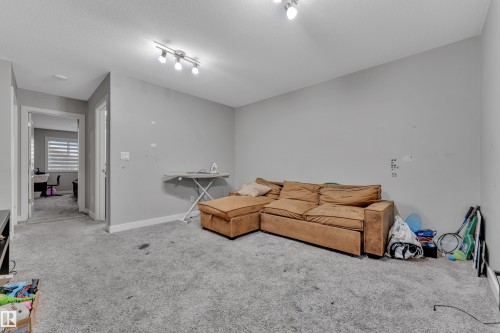 Spacious room featuring light gray wall paint and gray carpet flooring - 9328 Pear Link Link, Edmonton, AB 