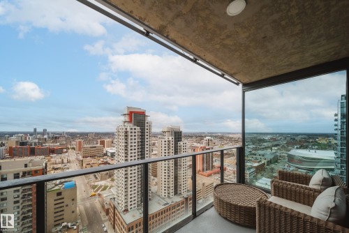 Outdoor balcony with glass panel railing, concrete ceiling, and recessed lighting - 2902 10180 103 Street, Edmonton, AB 