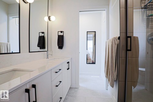 Dual-sink vanity with a light-toned countertop and integrated rectangular sinks - 12842 121 Street, Edmonton, AB 