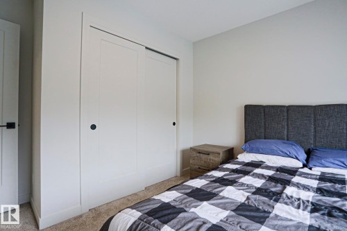 White sliding closet doors with black hardware - 12842 121 Street, Edmonton, AB 