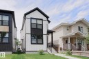 Contemporary exterior featuring white vertical siding with black trim accents - 12842 121 Street, Edmonton, AB 
