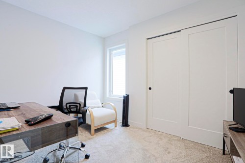Interior room featuring light gray carpeting and white painted walls - 12842 121 Street, Edmonton, AB 