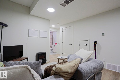 Recessed lighting illuminates this space featuring light wood-finish flooring - 12842 121 Street, Edmonton, AB 