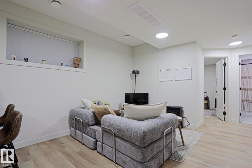 Recessed lighting throughout a versatile living space featuring wood-finish flooring - 12842 121 Street, Edmonton, AB 
