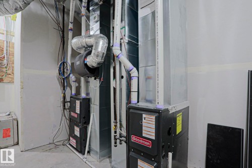 Dual Goodman furnaces with associated ductwork and piping - 12842 121 Street, Edmonton, AB 
