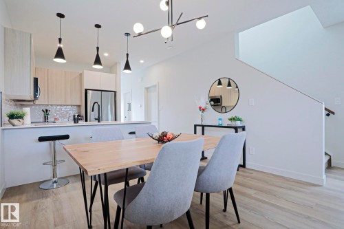 Open-concept living space with light wood-finish flooring - 12842 121 Street, Edmonton, AB 