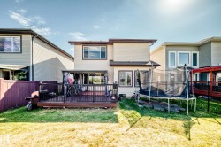 Rear exterior featuring a two-story design with light-colored siding - 