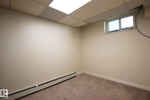 Carpeted room with a drop ceiling and recessed lighting - 11242 56 Street, Edmonton, AB 