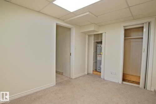 Carpeted room with drop ceiling and recessed lighting - 11242 56 Street, Edmonton, AB 