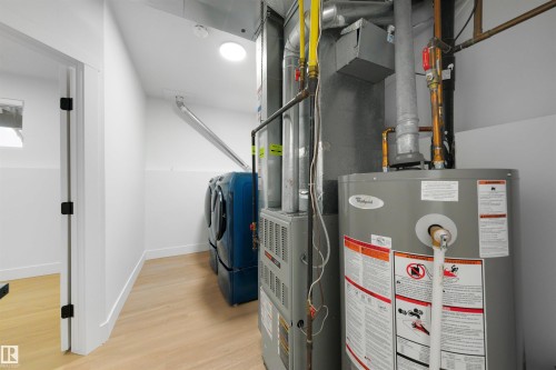 Dedicated mechanical room featuring a water heater and furnace - 12611 47 Street, Edmonton, AB 