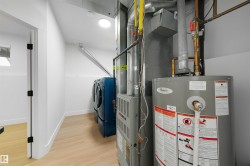 Dedicated mechanical room featuring a water heater and furnace - 