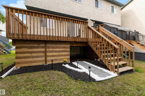 Elevated wood deck with baluster railing and staircase - 12611 47 Street, Edmonton, AB 