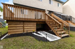 Elevated wood deck with baluster railing and staircase - 