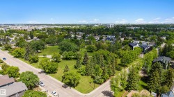 Expansive green space featuring mature trees and open lawn areas - 