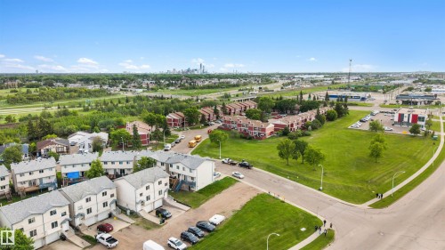 Aerial perspective showcasing multi-level townhome-style residences with individual garages and driveways - 12611 47 Street, Edmonton, AB 