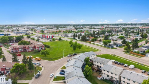 Aerial perspective showcasing red and light-colored multi-unit residential buildings - 12611 47 Street, Edmonton, AB 