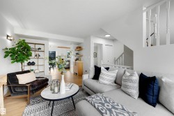 Bright open living area featuring light wood-finish flooring - 