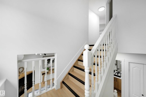 Hardwood staircase with white balusters and dark stair treads - 12611 47 Street, Edmonton, AB 