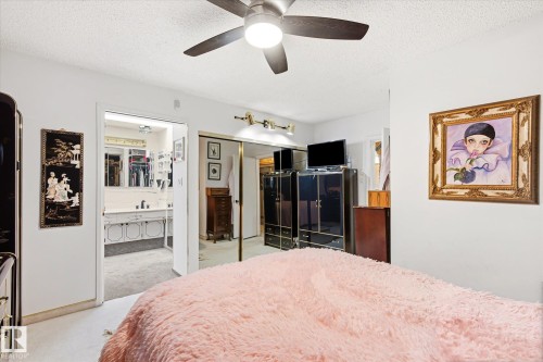 White walls with textured ceiling and a ceiling fan - 9747 67 Avenue, Edmonton, AB 