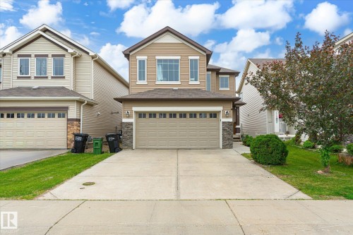 Two-story residence featuring light brown siding and stone accents - 1744 61 Street, Edmonton, AB 