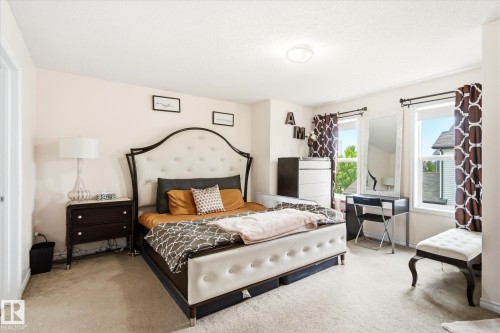 Carpeted room featuring light-colored walls and a ceiling-mounted light fixture - 1744 61 Street, Edmonton, AB 