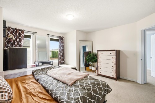 Carpeted room with light-toned walls and an overhead flush-mount light fixture - 1744 61 Street, Edmonton, AB 