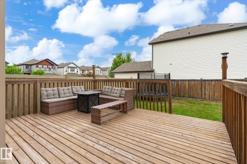 Spacious outdoor deck with natural wood planks and slatted railings, providing a dedicated area for outdoor enjoyment - 1744 61 Street, Edmonton, AB 