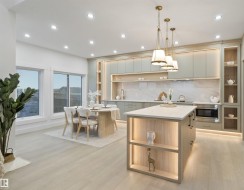 Open-concept kitchen and dining area featuring light wood-finish flooring - 