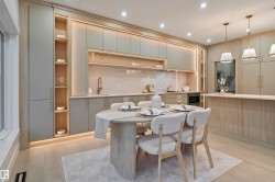 Contemporary kitchen and dining area featuring integrated cabinetry, recessed lighting, and under-cabinet illumination - 